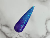 Photo shows swatch of Dipnotic Nails Temp-ermental Purple to Light Blue Flaky Thermal Nail Dip Powder The Frozen Fairy Collection