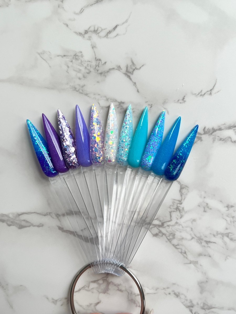 Photo shows swatch of Dipnotic Nails The Frozen Fairy Collection Blue and Purple Nail Dip Powder Collection