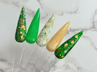 Photo shows swatch of Dipnotic Nails The Irish for a Day Collection Green and Gold St Patrick’s Day Dip Powder Collection